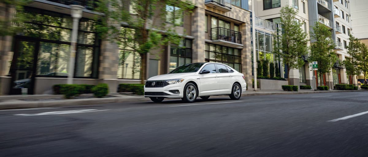 2019 Volkswagen Jetta A white 2019 VW Jetta driving through a city