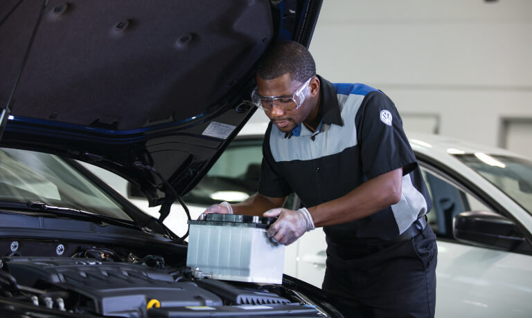 VW Service Tech Replacing Battery