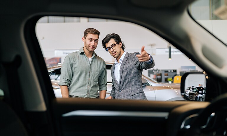 Salesman showing car