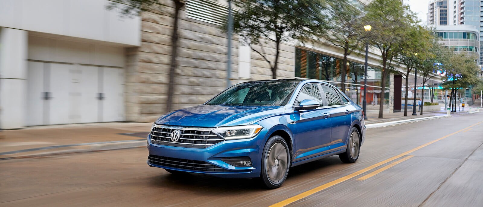 2020 VW Jetta A blue 2020 VW Jetta driving through a city