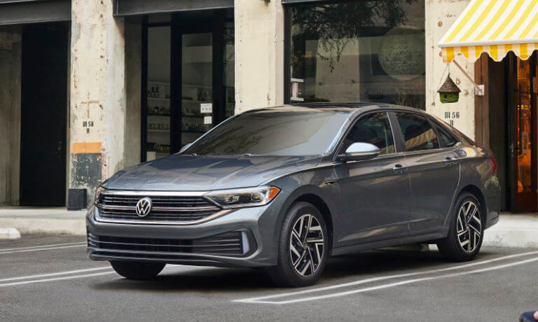 2022 VW Jetta parked in front of a shop