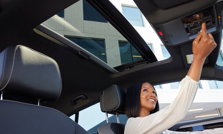 2022 VW Arteon with woman opening sunroof
