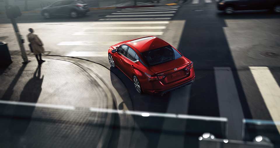 2019 Nissan Altima A red 2019 Nissan Altima turning a corner