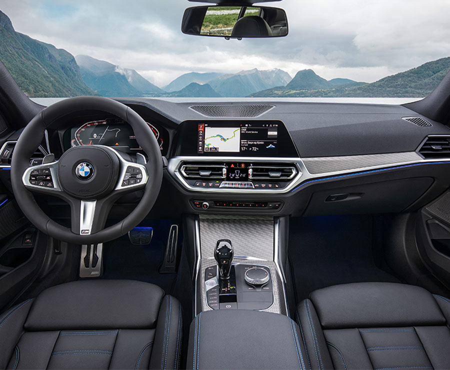 330i Interior dashboard overlooking a lake at the base of mountains
