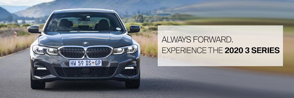 Front view of Grey BMW 3 Series on a road in a field. Always forward. Experience the 2020 3 Series