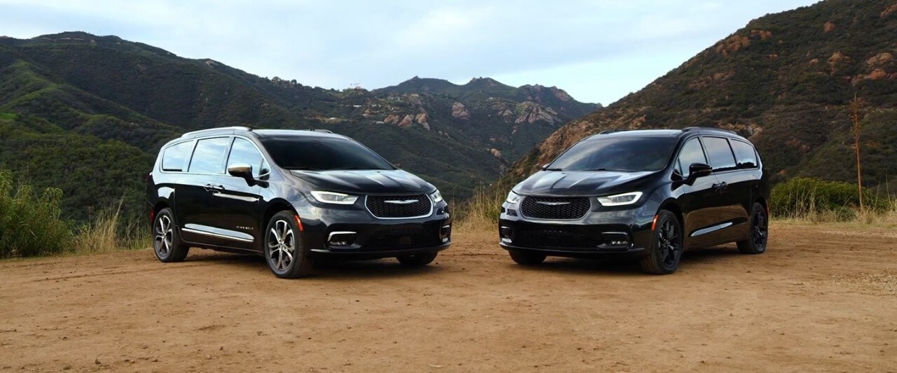 Two Chrysler Pacifica's parked on a mountain over look lot