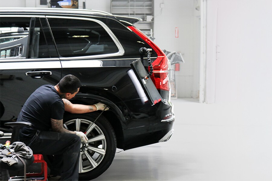 Technician at Patrick Collision Center performing paintless dent repair on a vehicle in Schaumburg