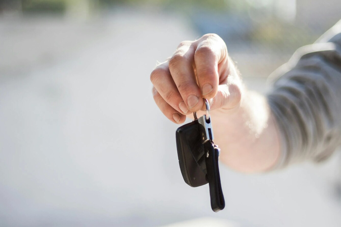 A hand holding the keys to a new car A hand holding the keys to a new car