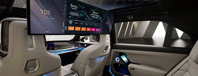 2025 BMW i7 rear-seat interior with 31-inch theater screen and ambient lighting