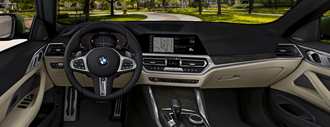BMW 4 Series black and tan interior showing infotainment system