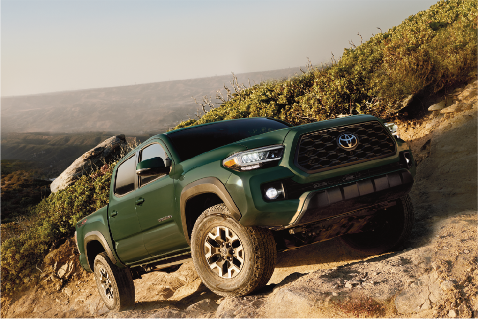 2022 Tacoma - Army Green - Action Shot - Side View Up Rocky Mountain.png