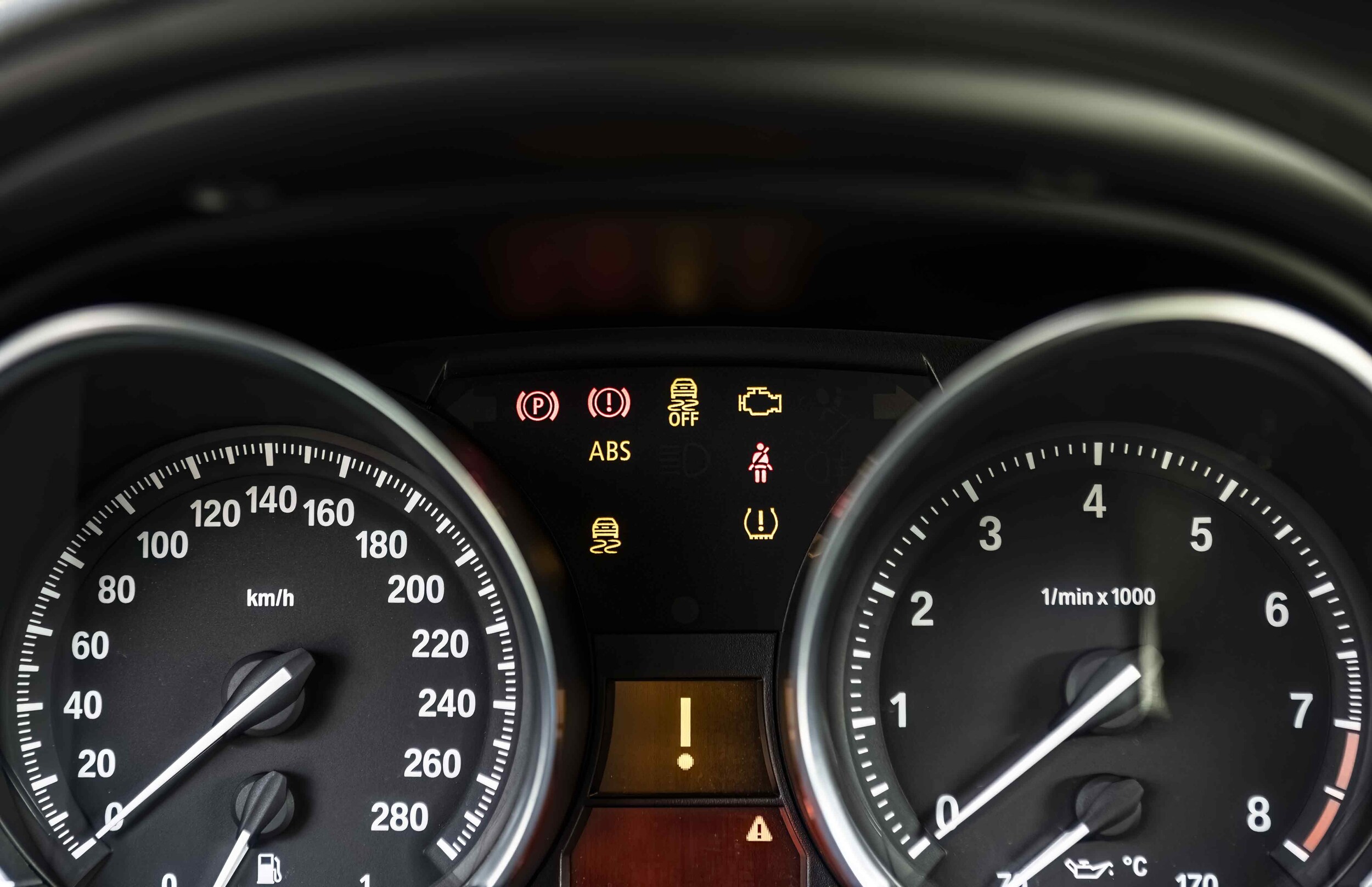 TITLE A vehicle dashboard with multiple warning light icons illuminated
