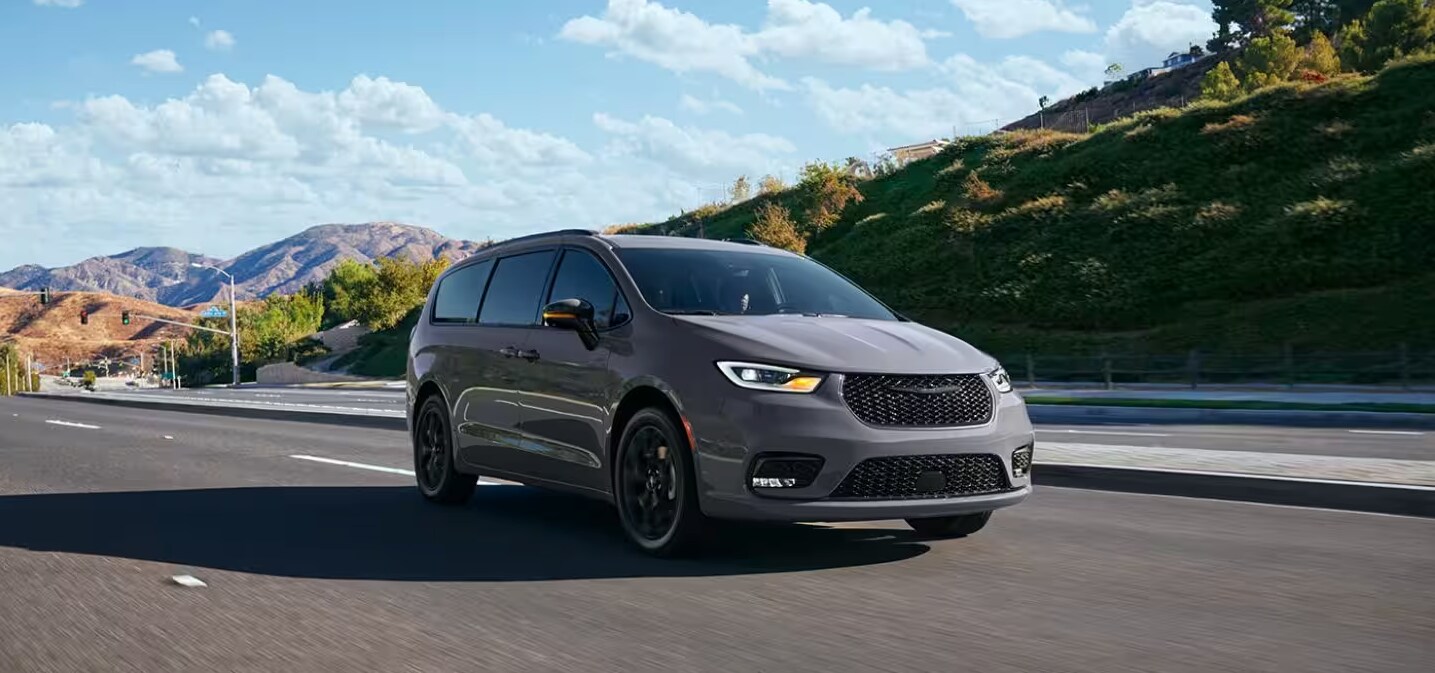 2024 Chrysler Pacifica driving past hills and mountains 2024 Chrysler Pacifica driving past hills and mountains