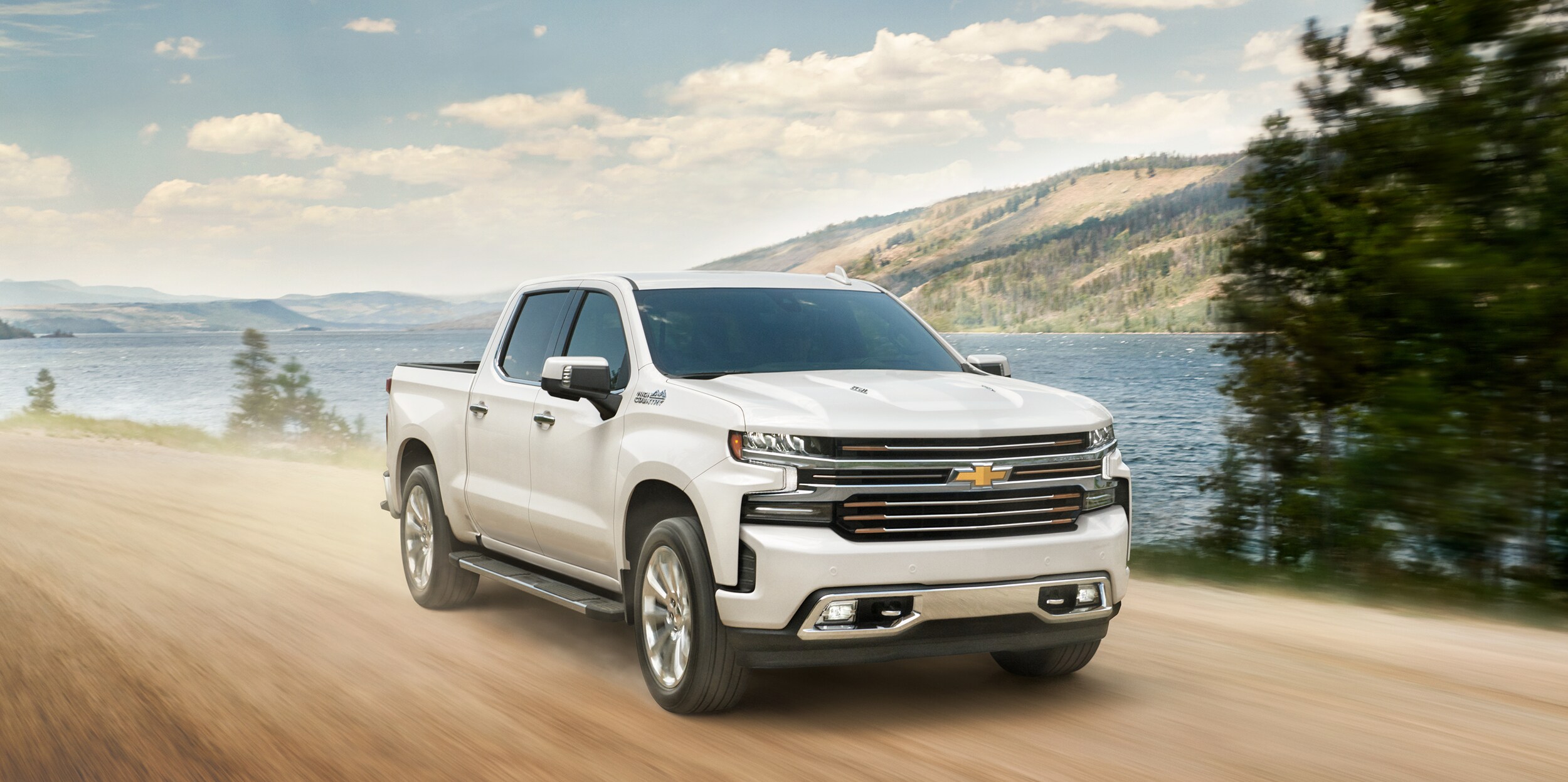Chevy Silverado 1500 driving on dirt road