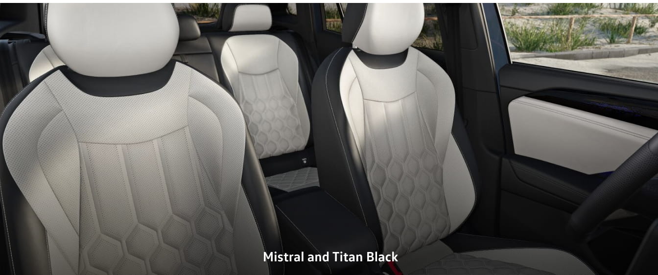 Volkswagen Tiguan interior with two-tone leather seats in Mistral and Titan Black. Hexagonal patterns and sleek design create a luxurious feel.