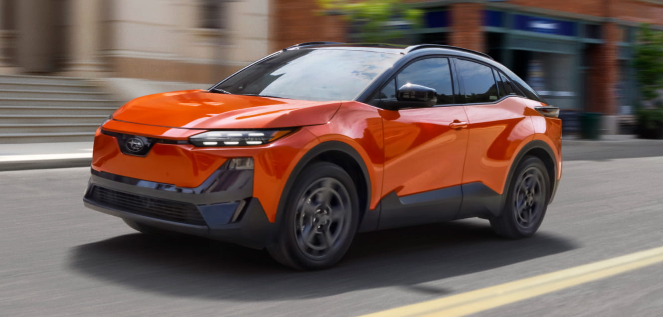 A sleek 2026 Subaru Uncharted speeds down an urban street.