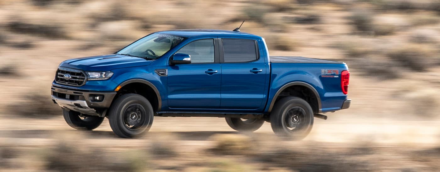 2021 Ford Ranger - 2021 Ford Ranger - Blue.jpg A blue 2021 Ford Ranger is shown from the side driving down a dusty road.