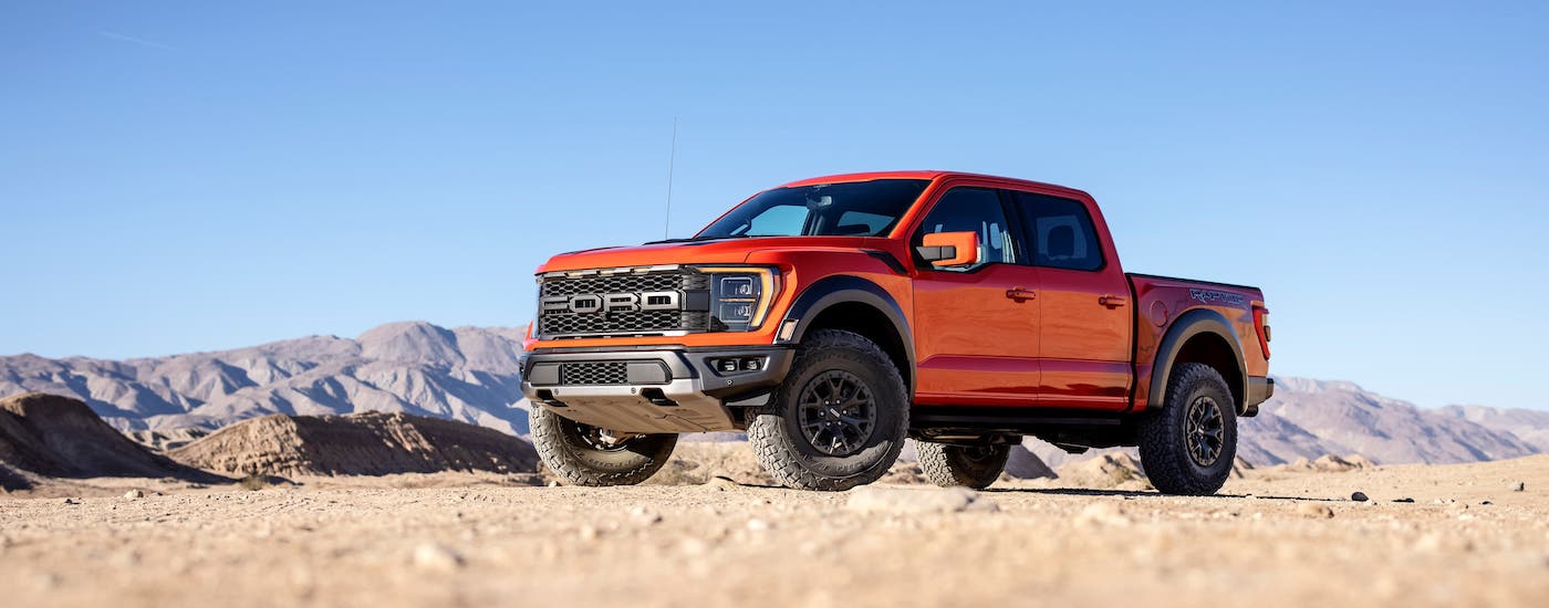 2021 Ford F-150 Raptor OVerview Wide.jpg A red 2021 Ford F-150 Raptor is parked on dirt in front of mountains and a blue sky.