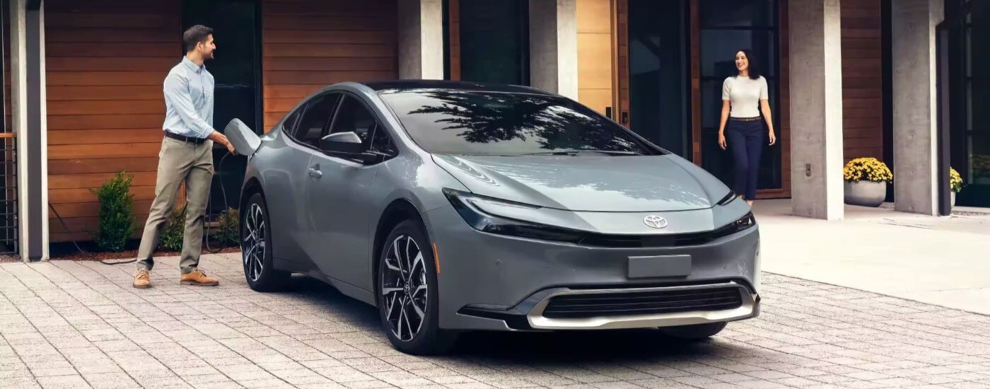 2023 Toyota Prius Prime XSE Premium - Couple.jpg Silver 2023 Toyota Prius XSE parked in a driveway