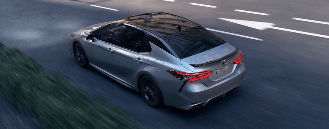Toyota%20Camry%20for%20sale%20near%20Nashville%20-%202023%20Toyota%20Camry%20Hybrid%20-%20Arrow.jpg White 2023 Toyota Camry Hybrid driving down a road.