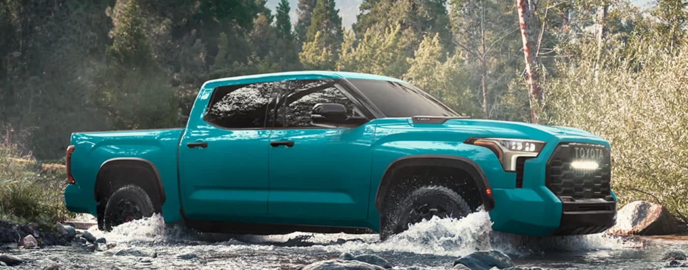 Blue 2026 Toyota Tundra TRD for sale near Clarksville driving off-road.
