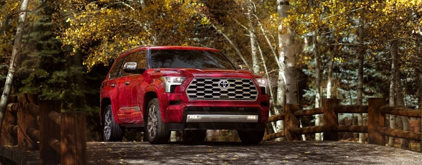 2023%20Toyota%20Sequoia%20Capstone%20-%20Birch.jpg Red 2023 Toyota Sequoia Capstone driving down a rural road