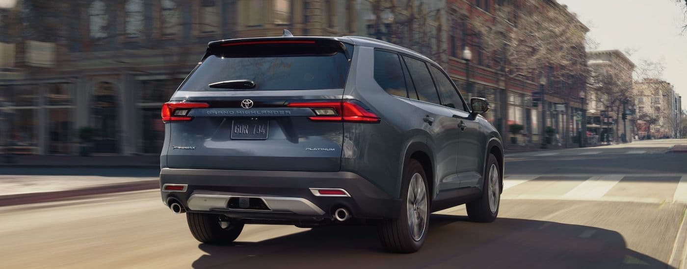 A grey 2024 Toyota Grand Highlander is shown from the rear at an angle.