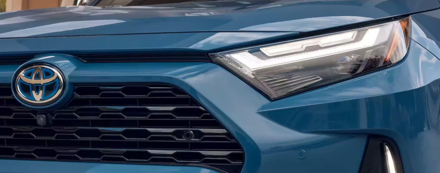 Toyota RAV4 Hybrid for sale - 2023 Toyota RAV4 Hybrid XSE - Blue.jpg A close up of the grille of a blue 2023 Toyota RAV4 XSE Hybrid for sale is shown.