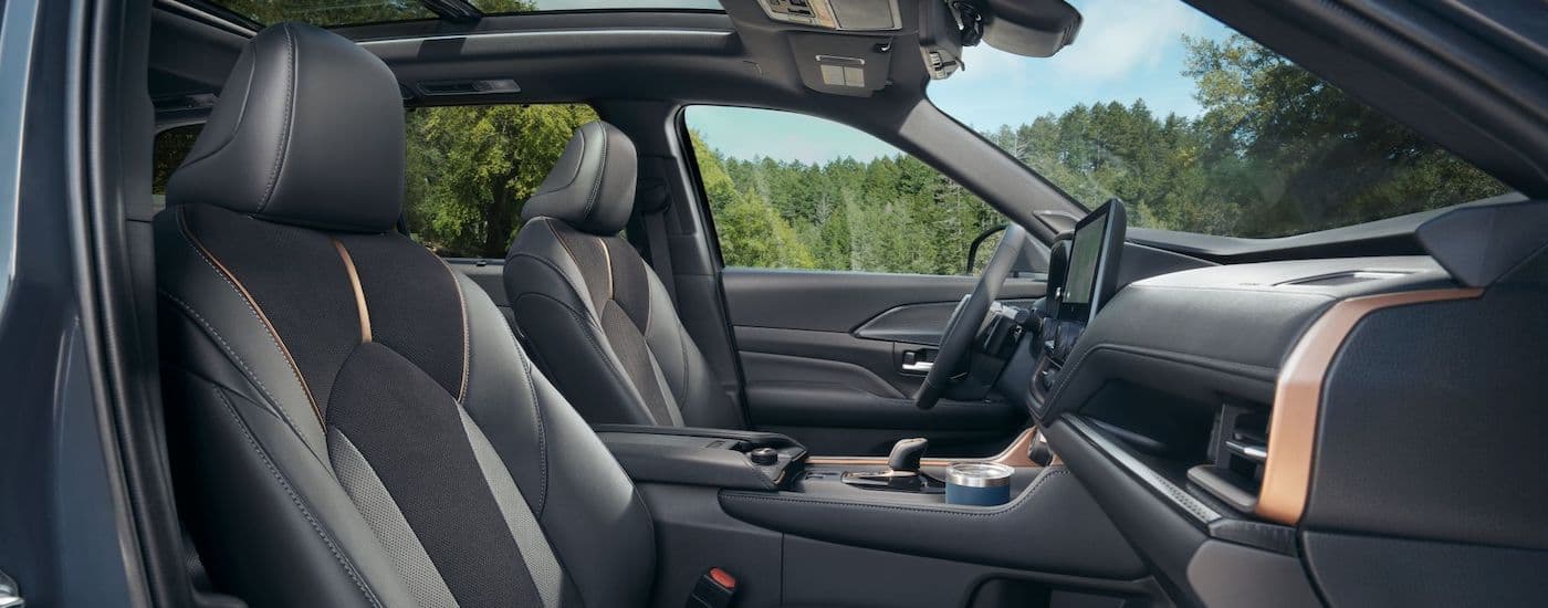 The interior of a 2024 Toyota Grand Highlander is shown from the passenger side.