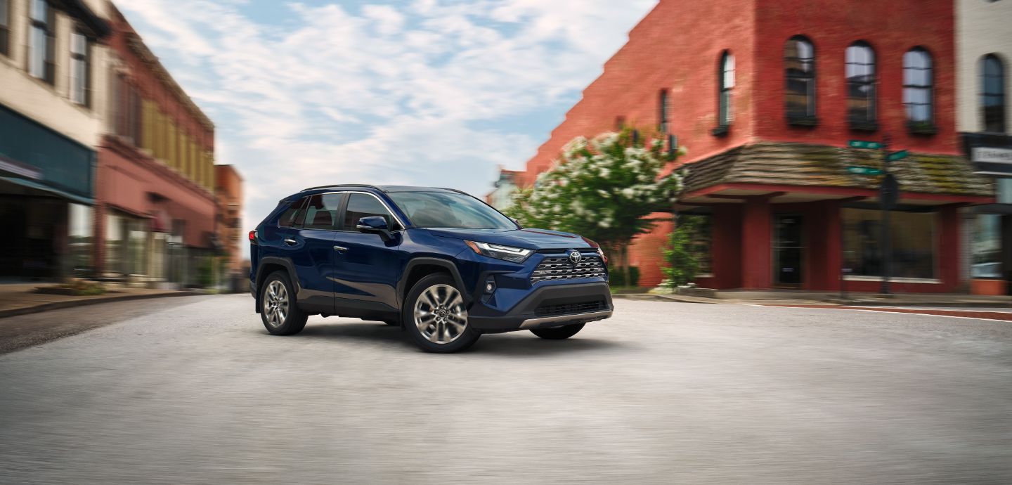 Blue 2025 RAV4 driving on street