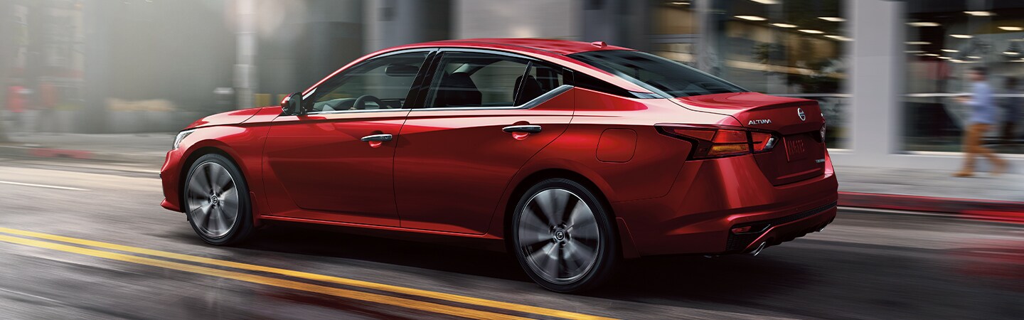 Rear side view of the red 2021 Nissan Altima for sale