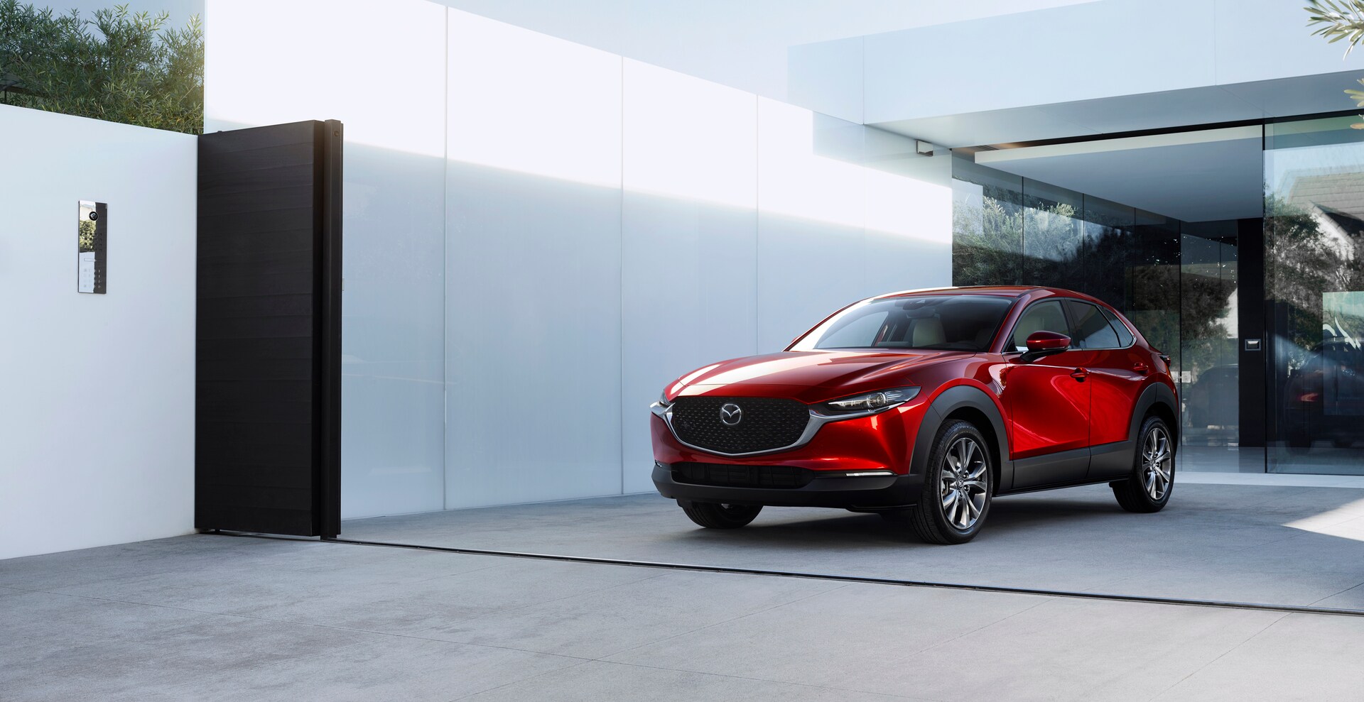 The new 2026 Mazda CX-30 parked in front of a home