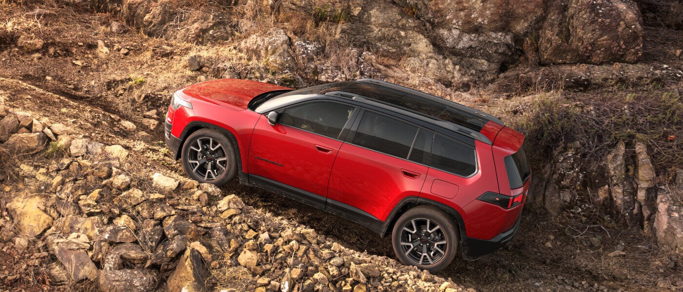 2026 Jeep Cherokee Exterior Driving Up Rocky Incline