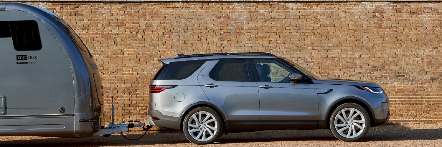 2024 Discovery Discovery SUV towing a camper