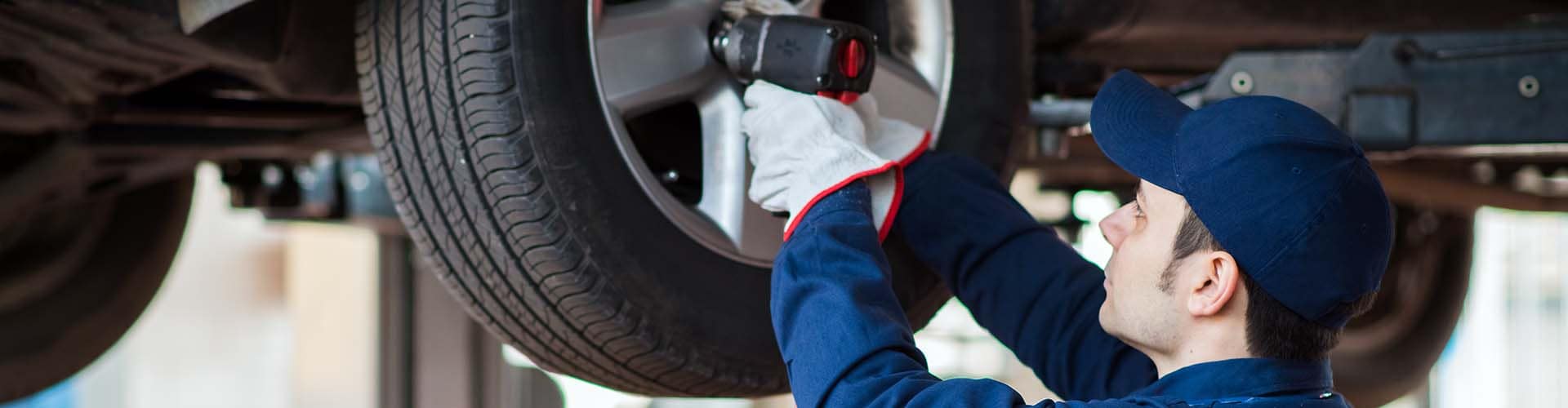 mechanic-with-tire_72032421_xl-2015-copy-1.jpg