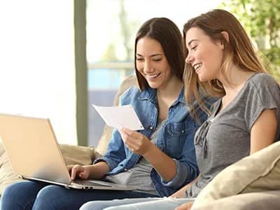 Two-women-looking-at-a-piece-of-paper.jpg