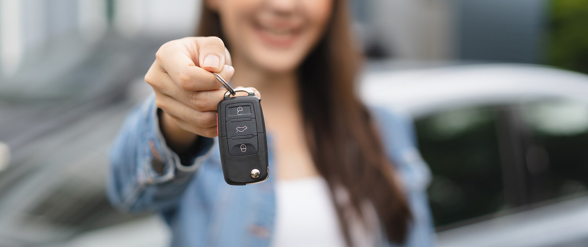 Why Buy Used from Valley River Chevrolet? Young woman showing off the keys to her used Chevrolet