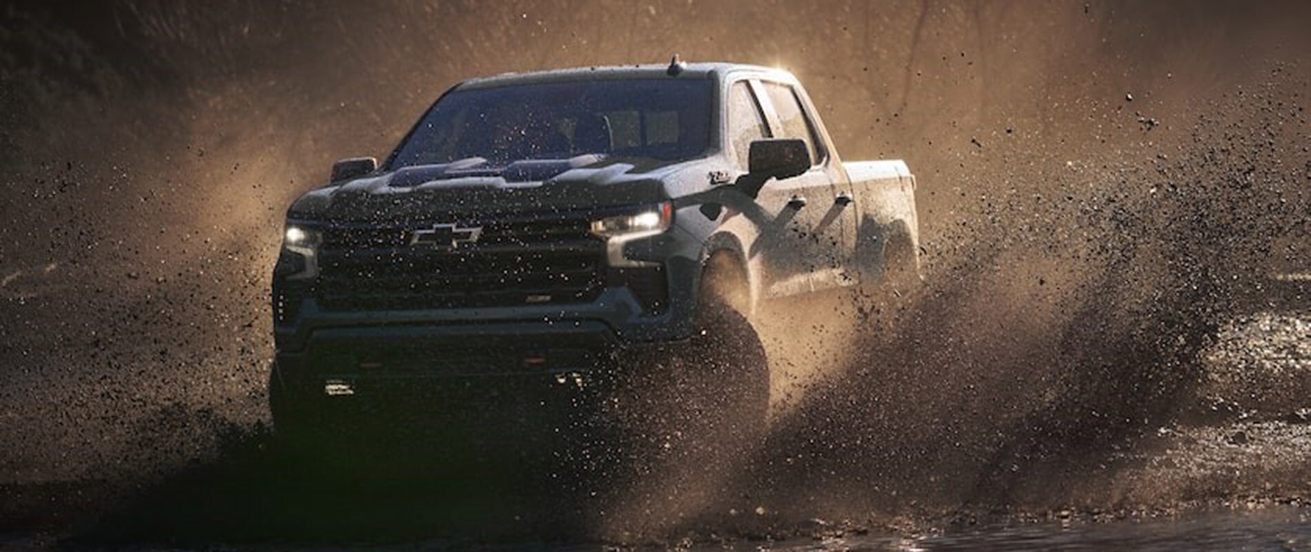 2026 Chevrolet Silverado 1500 Trim Comparison 2026 Chevrolet Silverado 1500 driving through muddy water