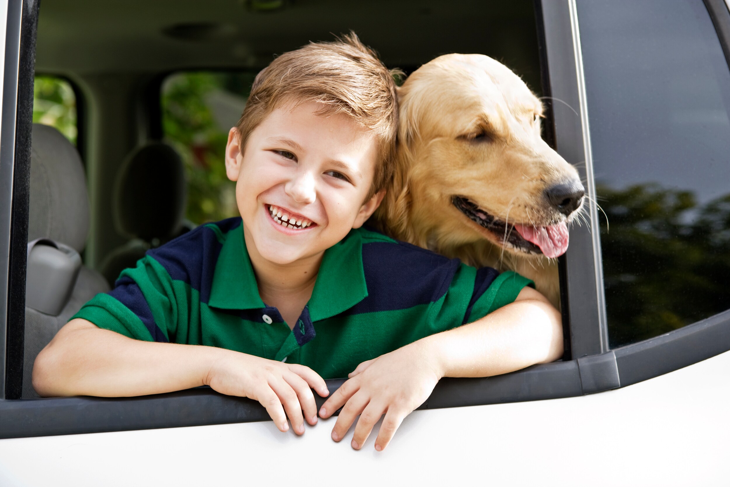 best-suvs-for-dogs-phil-long-valucar-academy-dealership-colorado-springs.jpg boy leaning out the car window with his dog