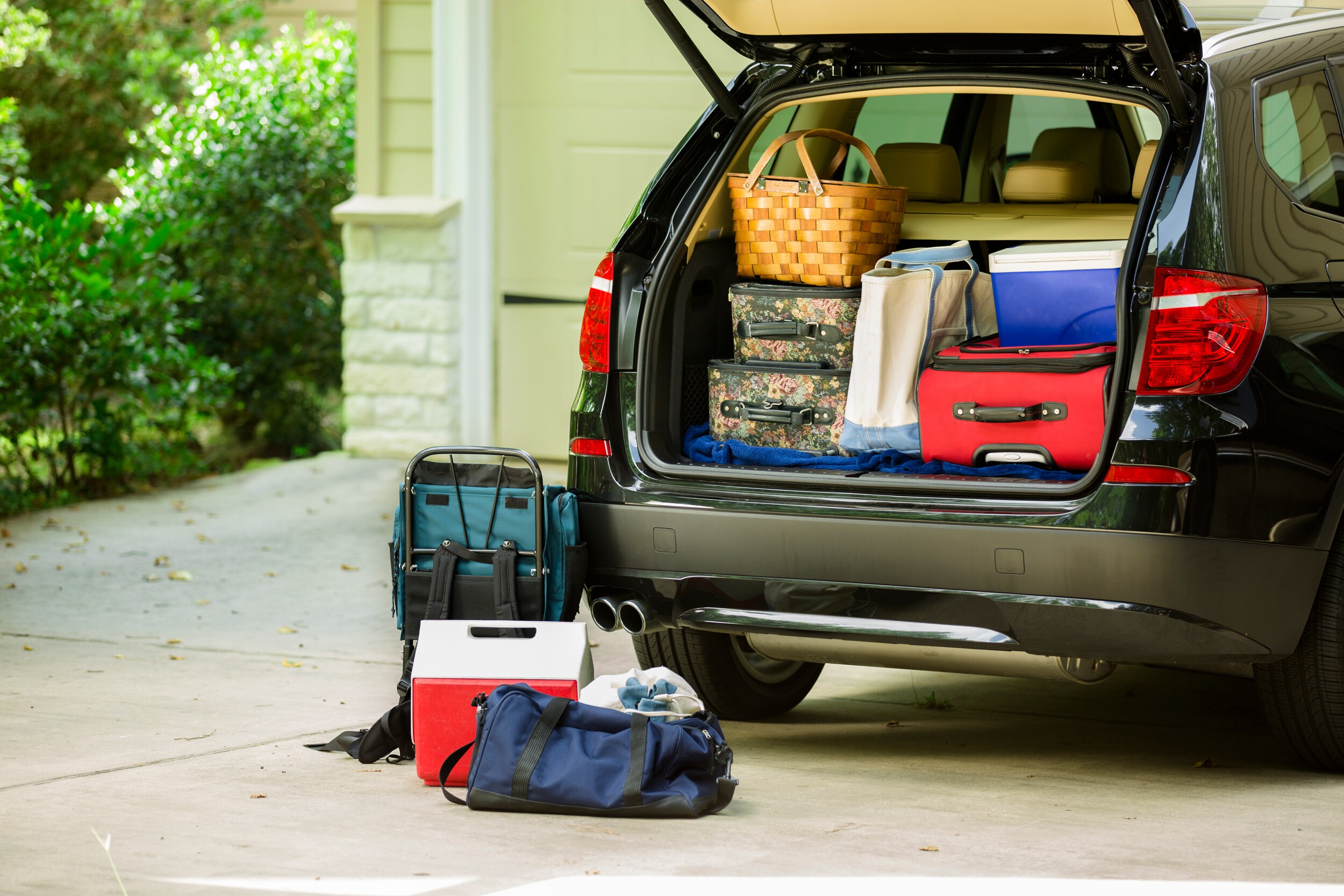 suvs-with-the-most-storage-space-phil-long-valucar-academy-dealership-colorado-springs.jpg SUV trunk open and packed with luggage, a picnic basket, and cooler