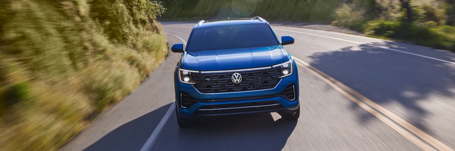 Volkswagen Atlas Cross Sport Volkswagen Atlas Cross Sport driving around a curve