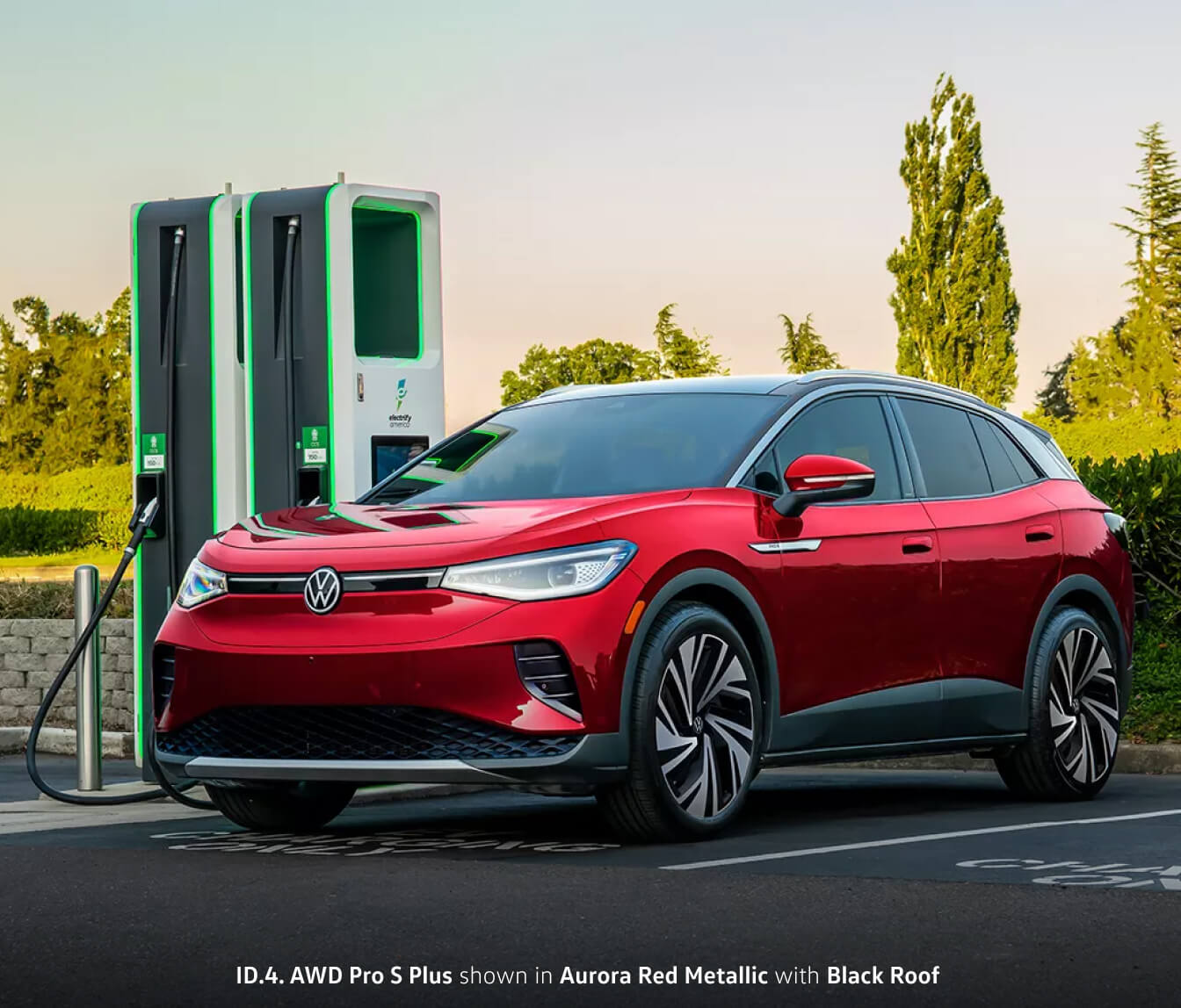 2024 Volkswagen ID.4 AWD Pro S Plus shown in Aurora Red Metallic with a black roof hooked up to an Electrify America EV Charger