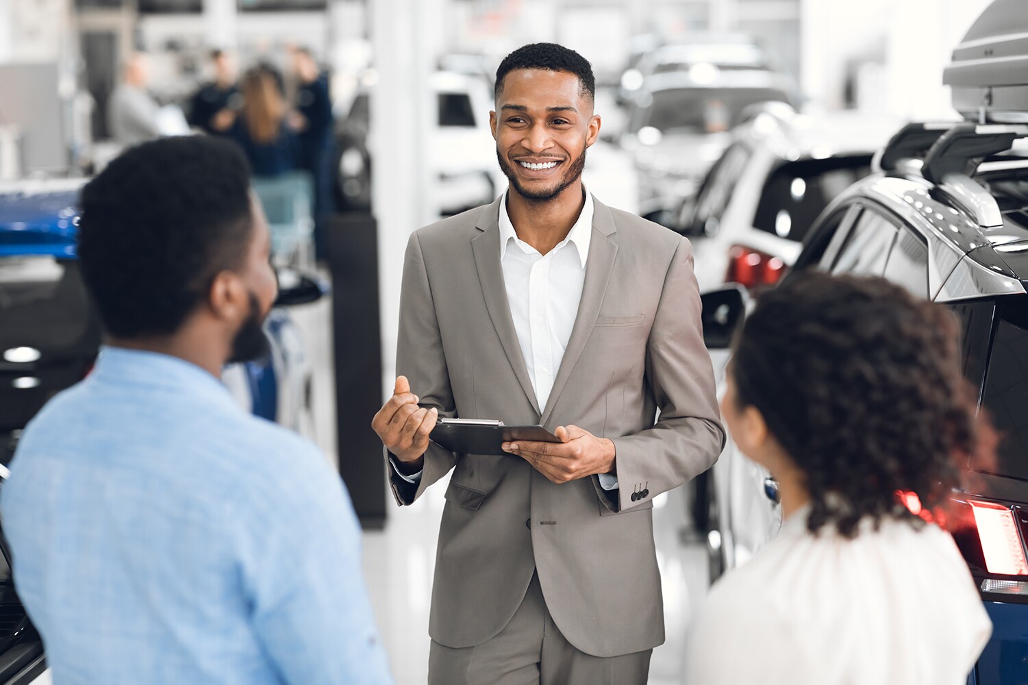 Volvo of New Bern is a Car Dealership in New Bern near Fairfield Harbor NC | Salesman talking to customers in dealership