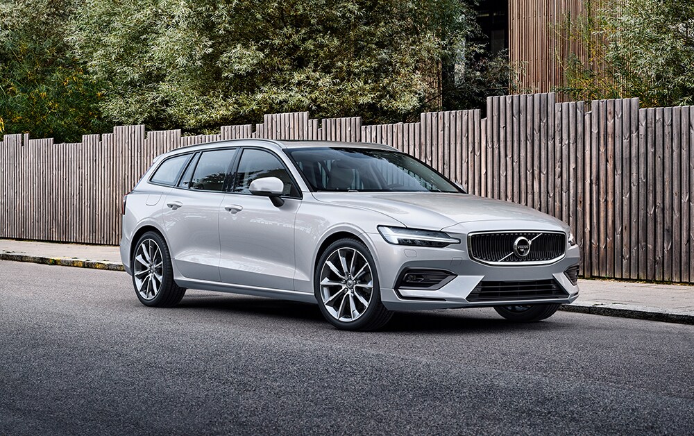 Volvo of New Bern is a Car Dealership in New Bern near Trent Woods, NC | Silver 2020 V60 Street Parked Next to Fence Volvo of New Bern is a Car Dealership in New Bern near Trent Woods, NC | Silver 2020 V60 Street Parked Next to Fence