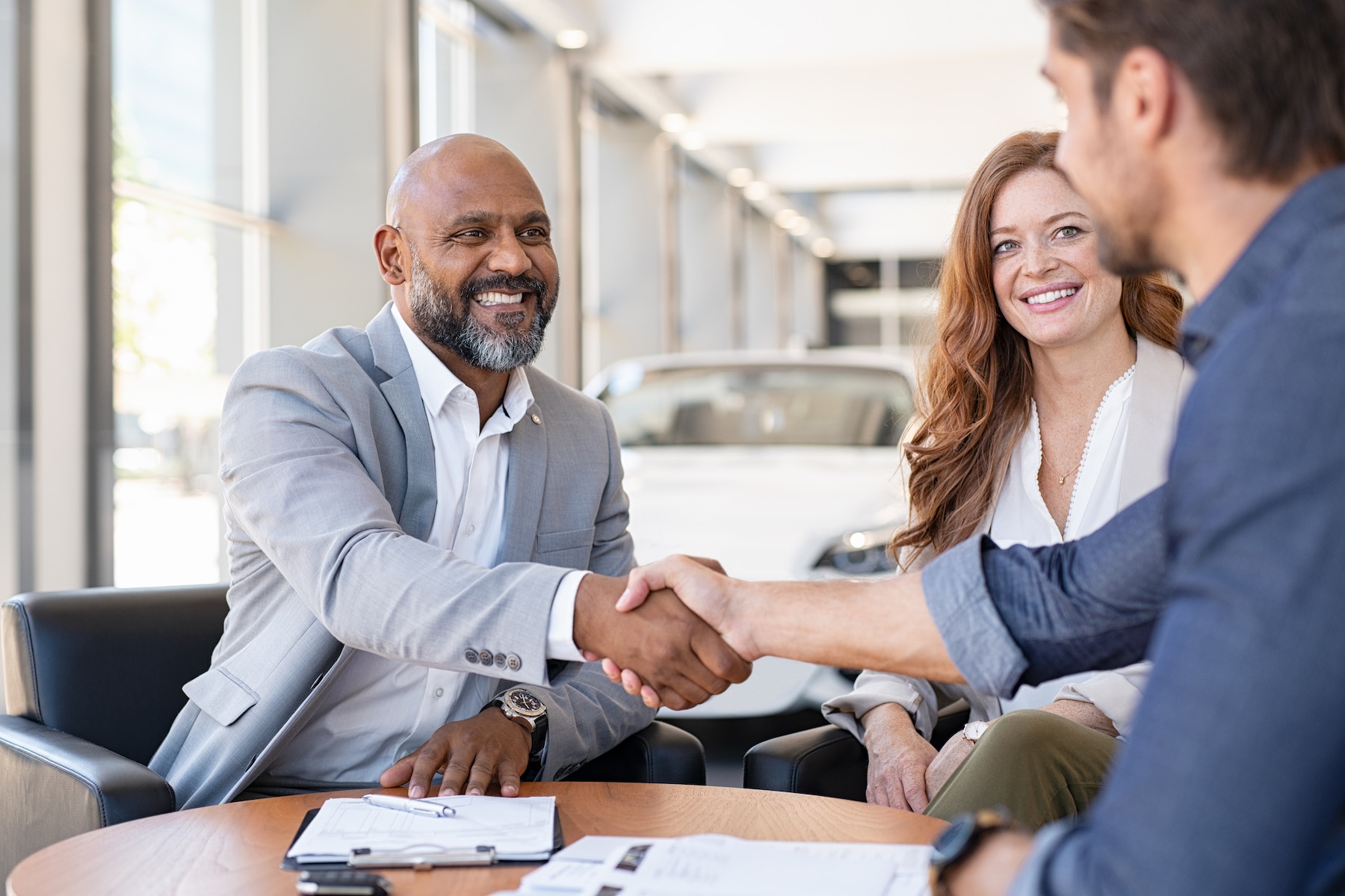 Who should I consult to get an accurate vehicle estimate at Volvo Cars New Bern of New Bern | sales agent shake shaking hand with customer Who should I consult to get an accurate vehicle estimate at Volvo Cars New Bern of New Bern | sales agent shake shaking hand with customer