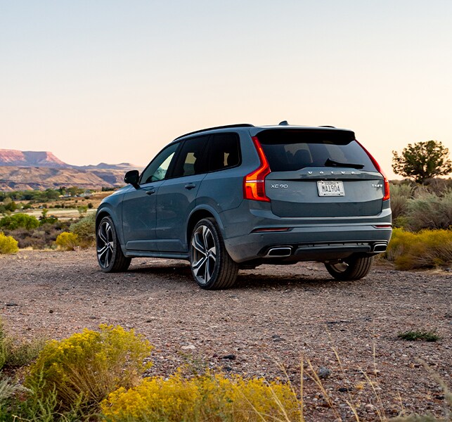 Leasing versus buying a Volvo at Volvo Cars New Bern | Rearview of Blue 2020 Volvo XC90 Parked in Desert