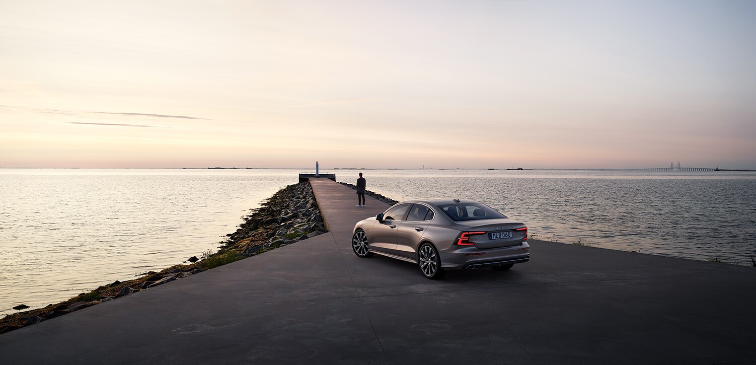 Volvo Cars New Bern is a Car Dealership near Bayboro, NC | 2020 Volvo S60 parked by the water during sunset