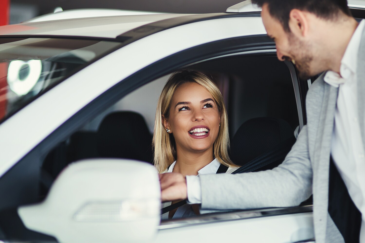 Volvo of New Bern is a Car Dealership in New Bern near Havelock NC | Woman talking to dealership salesman