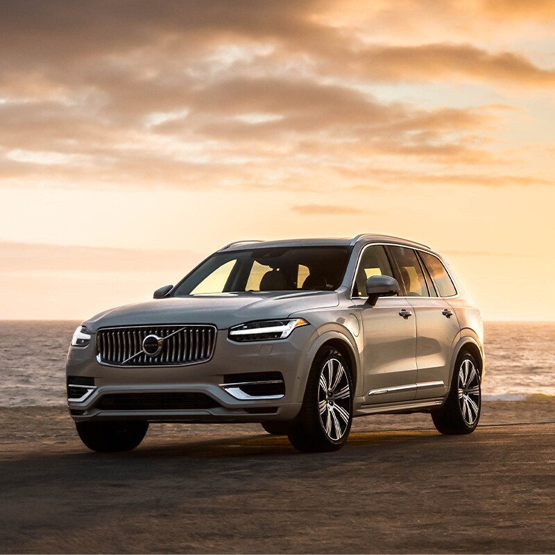 Volvo Cars New Bern is a Car Dealership near Beaufort NC | Silver XC90 Parked on Beach at Sunset Volvo Cars New Bern is a Car Dealership near Beaufort NC | Silver XC90 Parked on Beach at Sunset