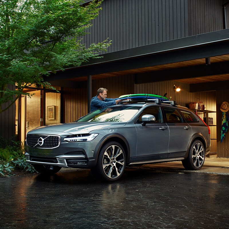 Volvo Cars New Bern is a Car Dealership near Beaufort NC | Silver V90 Parked in Front of Cabin Volvo Cars New Bern is a Car Dealership near Beaufort NC | Silver V90 Parked in Front of Cabin